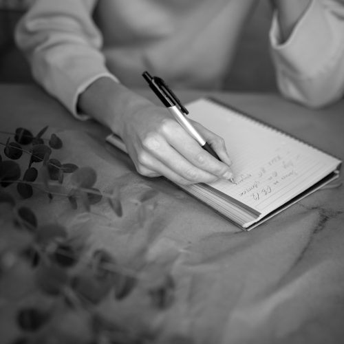 close-up-hand-writing-notebook